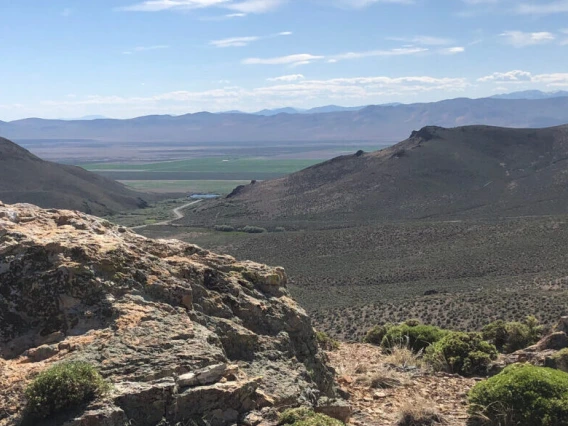 Image of desert landscape. Craigy mountains and winding road. 