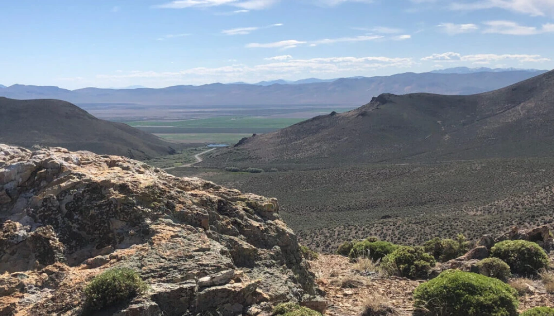 Image of desert landscape. Craigy mountains and winding road. 